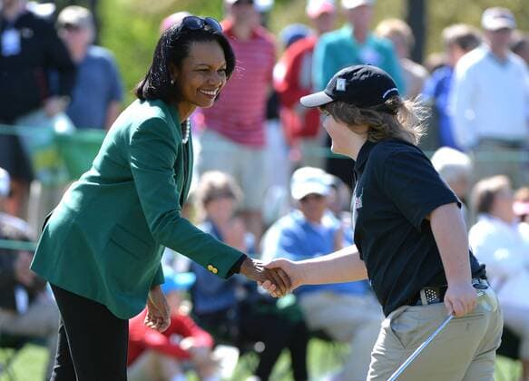 Former Secretary of State Condoleezza Rice shakes hands with Satchel Pierce of Union Michigan after he putted in the Boys 10-11 division of the Drive, Chip and Putt National Finals during Masters week at Augusta, National in Augusta, Georgia on April 5, 2015.  WAP20150405315 KEVINxDIETSCH