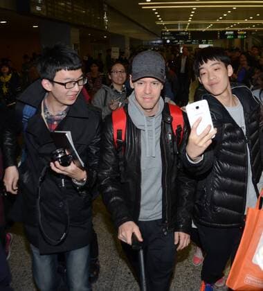German F1 driver Sebastian Vettel of Ferrari, center, is followed by fans after arriving at the Shanghai Pudong International Airport in Shanghai, China, 8 April 2015. Sebastian Vettel receives warm welcome in Shanghai  pbu255937_11