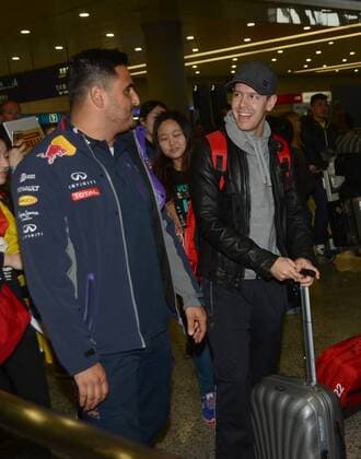 German F1 driver Sebastian Vettel of Ferrari, right, talks with staff of Red Bull Racing after arriving at the Shanghai Pudong International Airport in Shanghai, China, 8 April 2015. Sebastian Vettel receives warm welcome in Shanghai  pbu255937_18