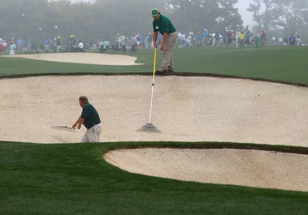 April 8, 2015 - Augusta, GA, USA - Course workers prepare the sand traps along the 18th fairway for the Masters on Wednesday, April 8, 2015, at Augusta National Golf Club in Augusta, Ga. Masters practice April 8 - ZUMAm67_