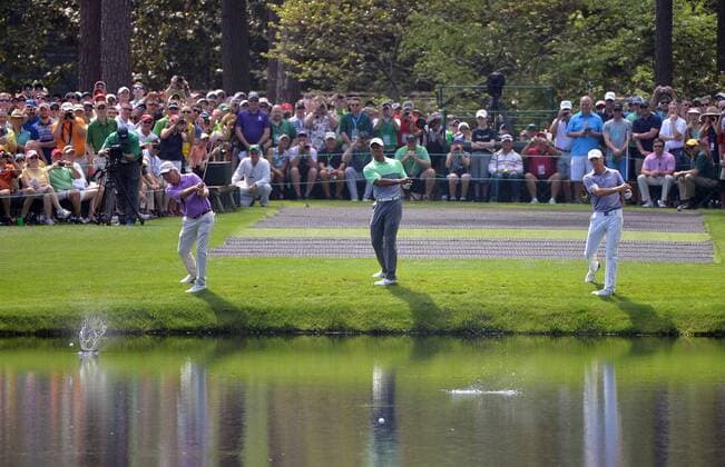 Ben Crenshaw, Tiger Woods and Jordan Spieth skip their ball across the pond on the 16th hole during a practice round at the 2015 Masters Tournament at Augusta, National in Augusta, Georgia on April 8, 2015.  AUG20150408303 KEVINxDIETSCH