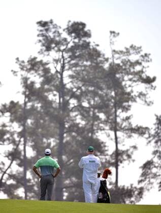 Tiger Woods and his caddy Joe LaCava wait to hit on the 17th fairway during a practice round at the 2015 Masters Tournament at Augusta, National in Augusta, Georgia on April 8, 2015.  AUG20150408310 KEVINxDIETSCH