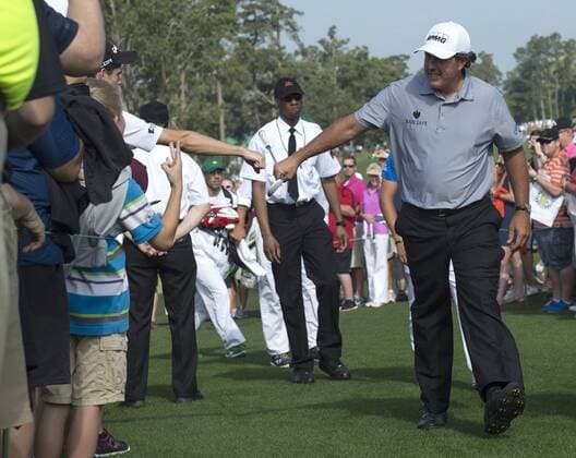 Phil Mickelson greets patrons after finishing his practice round at the 2015 Masters Tournament at Augusta, National in Augusta, Georgia on April 8, 2015.  AUG20150408328 KEVINxDIETSCH