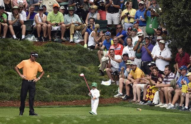 Bubba Watson watches as his son Caleb hits off of the 9th tee during the Par 3 contest at the 2015 Masters Tournament at Augusta, National in Augusta, Georgia on April 8, 2015.  AUG20150408369 KEVINxDIETSCH