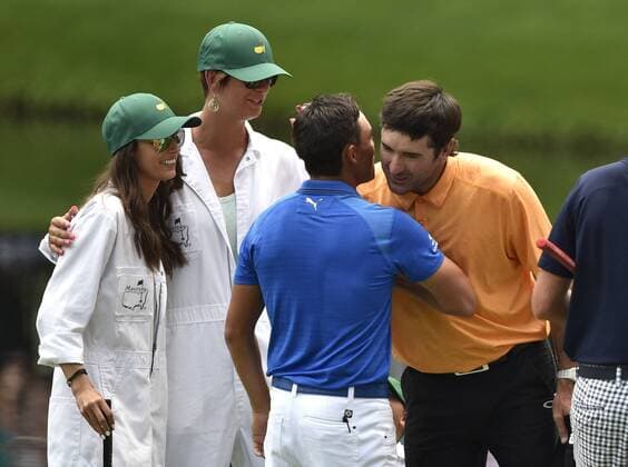 Bubba Watson hugs Rickie Fowler as they walk off the 9th green during the Par 3 contest at the 2015 Masters Tournament at Augusta, National in Augusta, Georgia on April 8, 2015.  AUG20150408372 KEVINxDIETSCH