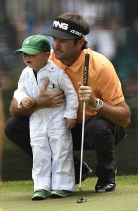 Bubba Watson hugs his son Caleb on the 9th green during the Par 3 contest at the 2015 Masters Tournament at Augusta, National in Augusta, Georgia on April 8, 2015.  AUG20150408374 KEVINxDIETSCH