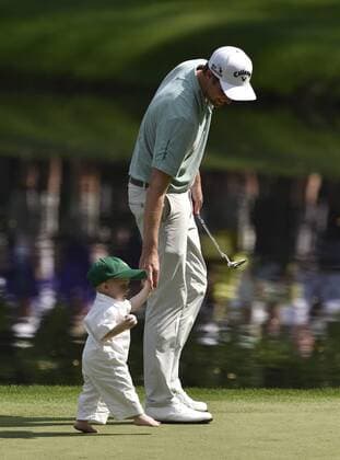 Chris Kirk and his son Sawyer walk on the 9th green during the Par 3 contest at the 2015 Masters Tournament at Augusta, National in Augusta, Georgia on April 8, 2015.  AUG20150408377 KEVINxDIETSCH