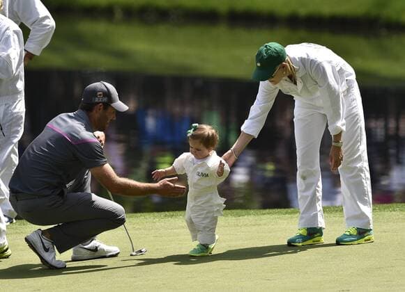 Charl Schwartzel and his wife Rosalind Jacobs play with their daughter Olivia on the 9th green during the Par 3 contest at the 2015 Masters Tournament at Augusta, National in Augusta, Georgia on April 8, 2015.  AUG20150408383 KEVINxDIETSCH