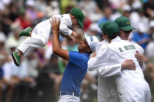 April 8, 2015 - Augusta, GA, USA - Rickie Fowler, center, lifts golfer Bubba Watson s son, Caleb into the air following play in the Par 3 Contest on Wednesday, April 8, 2015, at Augusta National Golf Club in Augusta, Ga. Masters practice April 8 - ZUMAm67_