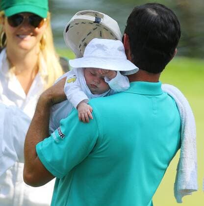 April 8, 2015 - Augusta, GA, USA - Robert Streb holds his exhausted daughter Catherine as he finishes his round on the ninth green during the Par 3 Contest on Wednesday, April 8, 2015, at Augusta National Golf Club in Augusta, Ga. Masters practice April 8 - ZUMAm67_