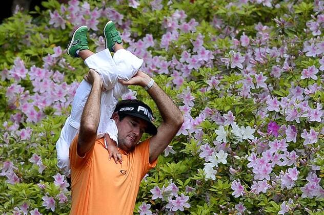 April 8, 2015 - Augusta, GA, USA - Bubba Watson carries his son Caleb upside down toward the ninth green during the Par 3 Contest on Wednesday, April 8, 2015, at Augusta National Golf Club in Augusta, Ga. Masters practice April 8 - ZUMAm67_