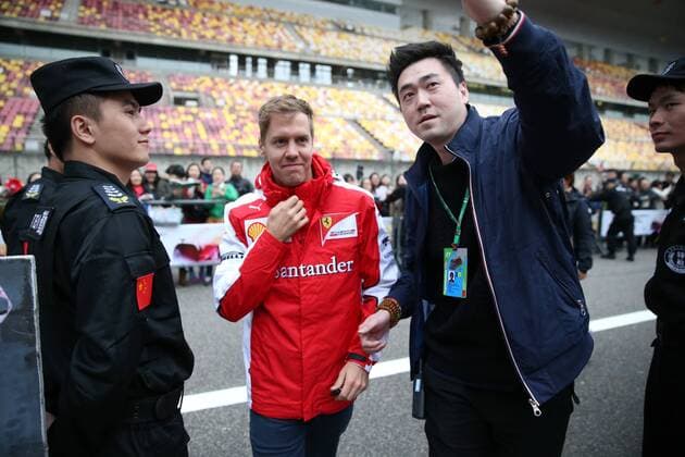 German F1 driver Sebastian Vettel of Ferrari, center, is pictured at the Shanghai International Circuit before the 2015 Formula 1 Chinese Grand Prix in Shanghai, China, 9 April 2015. F1 drivers wow fans with signatures and selfies in Shanghai  20150409_30143