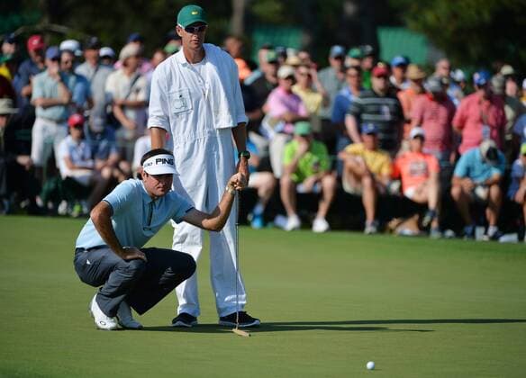 Bubba Watson and caddie Ted Scott line up a putt for eagle on the second green in the first round of the 2015 Masters Tournament at Augusta National Golf Club in Augusta, Georgia on April 9, 2015.  MAS20150409130 KEVINxDIETSCH