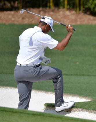 Tiger Woods reacts after hitting out of the sand to the third green in the first round the 2015 Masters Tournament at Augusta National Golf Club in Augusta, Georgia on April 9, 2015.  MAS20150409177 KEVINxDIETSCH