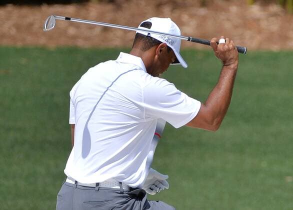Tiger Woods reacts after hitting out of the sand to the third green in the first round the 2015 Masters Tournament at Augusta National Golf Club in Augusta, Georgia on April 9, 2015.  MAS20150409178 KEVINxDIETSCH