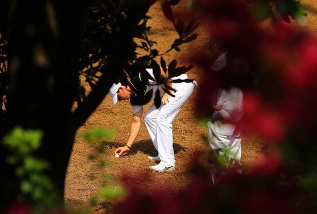 April 9, 2015 - Augusta, GA, USA - Seen through the foliage, Rory McIlroy has to take a drop off the 2 fairway during the first round at the Masters Golf Tournament, Thursday, April 9, 2015 in Augusta, Ga. Masters golf - ZUMAm67_