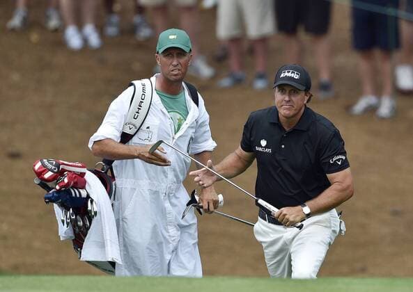 Caddie Jim Bones Mackay hands Phil Mickelson his putter after Phil chips on to the 10th green in the second round of the 2015 Masters Tournament at Augusta National Golf Club in Augusta, Georgia on April 10, 2015.  AUG20150410158 KEVINxDIETSCH