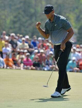 Tiger Woods pumps his fist after making a long putt for par on the 9th hole in the third round of the 2015 Masters Tournament at Augusta National Golf Club in Augusta, Georgia on April 11, 2015.  AUG20150411111 KEVINxDIETSCH