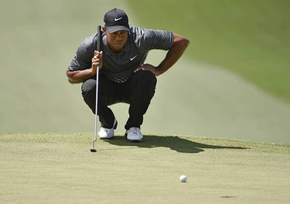 Tiger Woods lines up a putt on the 7th hole in the third round of the 2015 Masters Tournament at Augusta National Golf Club in Augusta, Georgia on April 11, 2015.  AUG20150411113 KEVINxDIETSCH