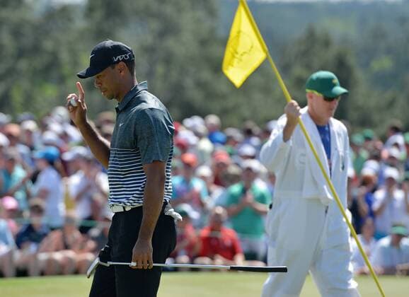 Tiger Woods reacts after making a long putt for par on the 9th hole in the third round of the 2015 Masters Tournament at Augusta National Golf Club in Augusta, Georgia on April 11, 2015.  AUG20150411115 KEVINxDIETSCH