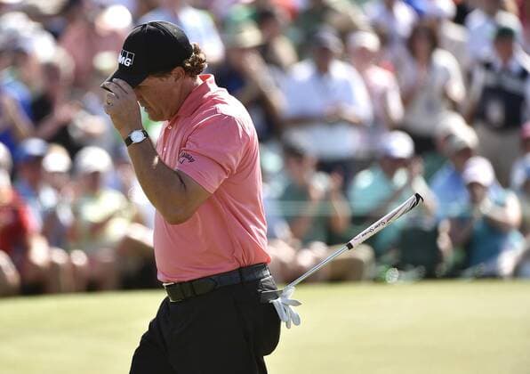 Phil Mickelson tips his cap while walking off of the 9th green after making a birdie in the third round of the 2015 Masters Tournament at Augusta National Golf Club in Augusta, Georgia on April 11, 2015.  AUG20150411117 KEVINxDIETSCH