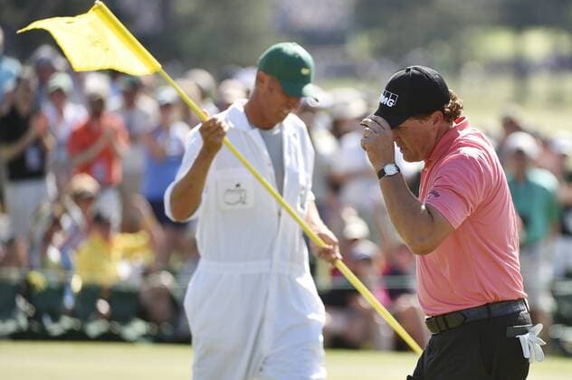 Phil Mickelson tips his cap while walking off of the 9th green after making a birdie in the third round of the 2015 Masters Tournament at Augusta National Golf Club in Augusta, Georgia on April 11, 2015.  AUG20150411119 KEVINxDIETSCH
