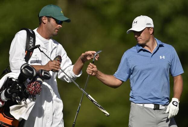 Jordan Spieth and caddie Michael Greller exchange clubs in the third round of the 2015 Masters Tournament at Augusta National Golf Club in Augusta, Georgia on April 11, 2015.  AUG20150411143 KEVINxDIETSCH