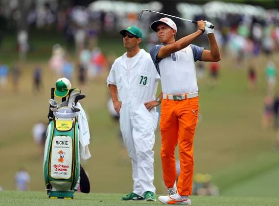 April 12, 2015 - Augusta, GA, USA - Rickie Fowler and his caddie, Joseph Skovron, watch his shot from the first fairway during the final round of the Masters on Sunday, April 12, 2015, at Augusta National Golf Club in Augusta, Ga. Masters final round - ZUMAm67_