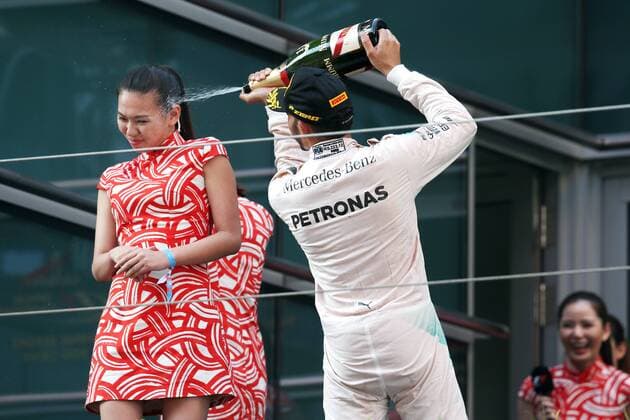 Britain s Lewis Hamilton of Mercedes, right, sprays champagne on the face of a hostess during the award ceremony of the 2015 Formula 1 Chinese Grand Prix at the Shanghai International Circuit in Shanghai, China, 12 April 2015. Chinese Grand Prix in Shanghai  20150412_30344
