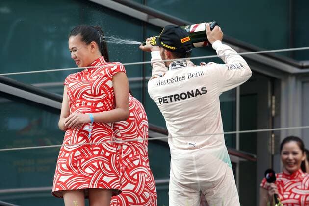 Britain s Lewis Hamilton of Mercedes, right, sprays champagne on the face of a hostess during the award ceremony of the 2015 Formula 1 Chinese Grand Prix at the Shanghai International Circuit in Shanghai, China, 12 April 2015. Chinese Grand Prix in Shanghai  20150412_44778