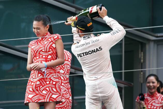 Britain s Lewis Hamilton of Mercedes, right, sprays champagne on the face of a hostess during the award ceremony of the 2015 Formula 1 Chinese Grand Prix at the Shanghai International Circuit in Shanghai, China, 12 April 2015. Chinese Grand Prix in Shanghai  20150412_64347