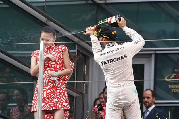 Britain s Lewis Hamilton of Mercedes, right, sprays champagne on the face of a hostess during the award ceremony of the 2015 Formula 1 Chinese Grand Prix at the Shanghai International Circuit in Shanghai, China, 12 April 2015. Chinese Grand Prix in Shanghai  pbu258197_03