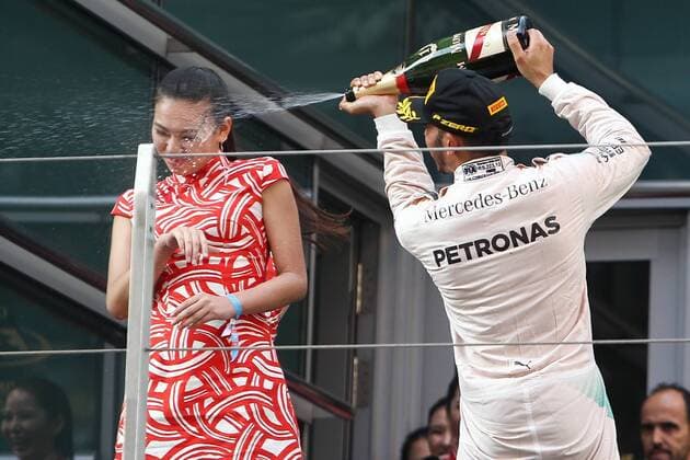 Britain s Lewis Hamilton of Mercedes, right, sprays champagne on the face of a hostess during the award ceremony of the 2015 Formula 1 Chinese Grand Prix at the Shanghai International Circuit in Shanghai, China, 12 April 2015. Chinese Grand Prix in Shanghai  pbu258197_05