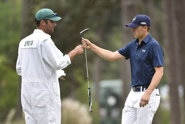 Jordan Spieth celebrates with caddie Michael Greller after Spieth makes a putt for birdie on the 3rd hole in the final round of the 2015 Masters Tournament at Augusta National Golf Club in Augusta, Georgia on April 12, 2015.  AUG20150412104 KEVINxDIETSCH