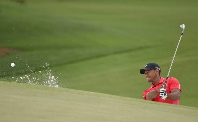 Tiger Woods hits out of a bunker on the 7th hole in the final round of the 2015 Masters Tournament at Augusta National Golf Club in Augusta, Georgia on April 12, 2015.  AUG20150412132 KEVINxDIETSCH