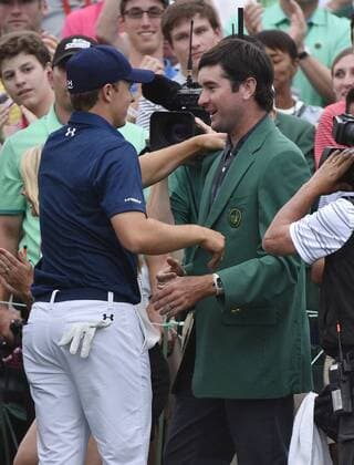 Bubba Watson congratulates Jordan Spieth on the 18th green after Spieth wins the 2015 Masters Tournament at Augusta National Golf Club in Augusta, Georgia on April 12, 2015. Jordan Spieth won his first major championship with a score of 18 under par.  AUG20150412147 KEVINxDIETSCH