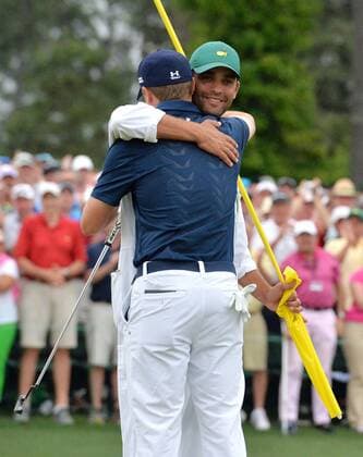 Caddie Michael Greller hugs Jordan Spieth when they celebrate on the 18th green after Spieth wins the 2015 Masters Tournament at Augusta National Golf Club in Augusta, Georgia on April 12, 2015. Jordan Spieth wins his first major championship with a score of 18 under par.  AUG20150412152 KEVINxDIETSCH