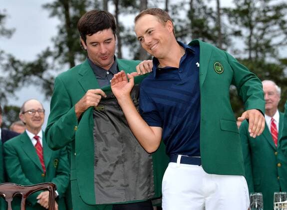 2014 Masters champion Bubba Watson puts the ceremonial Green Jacket on Jordan Spieth for the first time after Spieth wins the 2015 Masters Tournament at Augusta National Golf Club in Augusta, Georgia on April 12, 2015. Jordan Spieth wins his first major championship with a score of 18 under par.  AUG20150412161 KEVINxDIETSCH