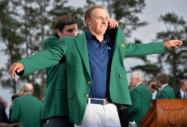 2014 Masters champion Bubba Watson puts the ceremonial Green Jacket on Jordan Spieth for the second time after Spieth wins the 2015 Masters Tournament at Augusta National Golf Club in Augusta, Georgia on April 12, 2015. Jordan Spieth wins his first major championship with a score of 18 under par.  AUG20150412164 KEVINxDIETSCH