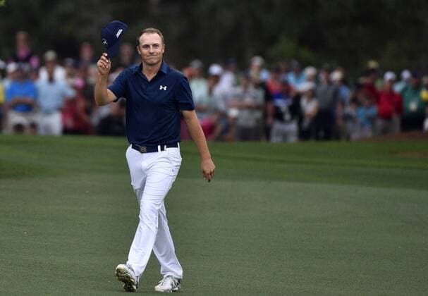 Jordan Spieth tips his hat as he walks up to the 18th green with a 4 stroke lead before winning the 2015 Masters Tournament at Augusta National Golf Club in Augusta, Georgia on April 12, 2015. Jordan Spieth wins his first major championship with a score of 18 under par.  AUG20150412172 KEVINxDIETSCH