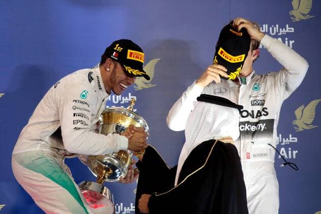 FORMULA 1 - Bahrain GP SAKHIR,BAHRAIN,19.APR.15 - MOTORSPORTS, FORMULA 1 - Grand Prix of Bahrain, Bahrain International Circuit, award ceremony. Image shows Lewis Hamilton (GBR Mercedes GP) with the trophy and Nico Rosberg (GER Mercedes GP). GEPAxpictures xFritzxMueller 