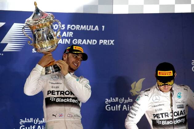 FORMULA 1 - Bahrain GP SAKHIR,BAHRAIN,19.APR.15 - MOTORSPORTS, FORMULA 1 - Grand Prix of Bahrain, Bahrain International Circuit, award ceremony. Image shows Lewis Hamilton (GBR Mercedes GP) with the trophy and Nico Rosberg (GER Mercedes GP). GEPAxpictures xFritzxMueller 