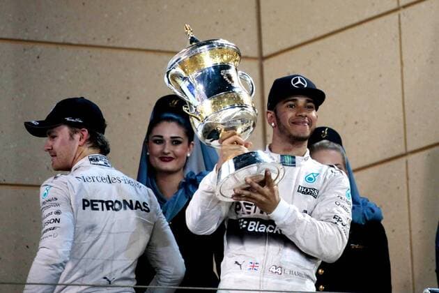 FORMULA 1 - Bahrain GP SAKHIR,BAHRAIN,19.APR.15 - MOTORSPORTS, FORMULA 1 - Grand Prix of Bahrain, Bahrain International Circuit, award ceremony. Image shows Lewis Hamilton (GBR Mercedes GP) with the trophy and Nico Rosberg (GER Mercedes GP). GEPAxpictures xFritzxMueller 