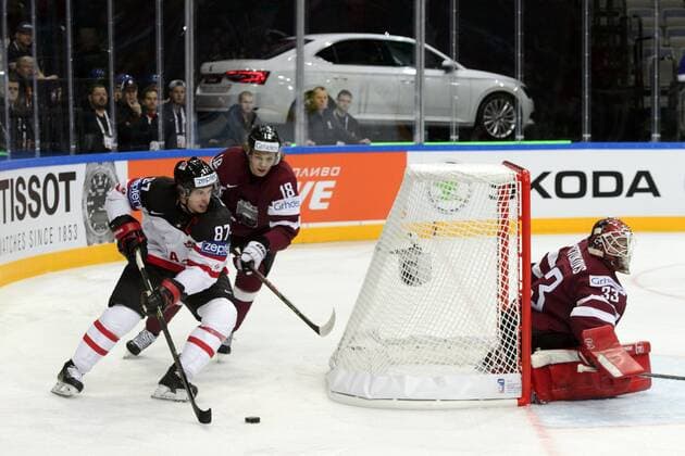 Sidney Crosby of Canada, left, controls a puck past Latvia s Rodrigo Abols, center, and Latvia s goalkeeper Ervins Mustukovs, right, during the Ice hockey Eishockey World Championship WM Weltmeisterschaft Group A match Canada vs Latvia in Prague, Czech Republic, May 1, 2015. (CTKxPhoto MichalxKamaryt) CTKPhotoP201505010550501  kmt 3