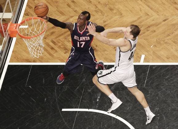 Brooklyn Nets Bojan Bogdanovic defends Atlanta Hawks Dennis Schroder who shoots a lay up in the first half of Game 6 in the first round of the NBA Basketball Herren USA Eastern Conference playoffs at Barclays Center in New York City on May 1, 2015.  NYP20150501102 JOHNxANGELILLO