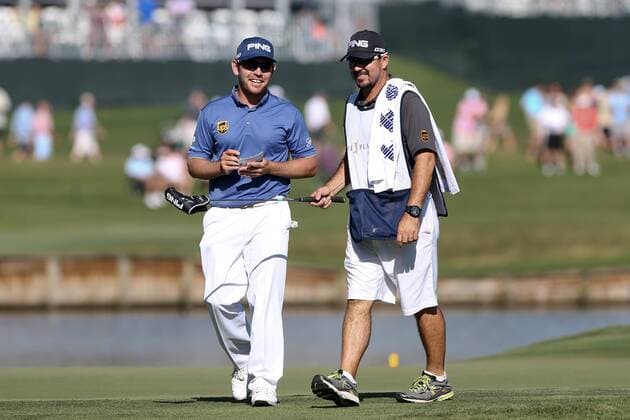 May 7, 2015 - Ponte Vedra Beach, Florida, United States - Louis Oosthuizen (L) and his caddie walk off the 7th green during the first round of THE PLAYERS Championship. THE PLAYERS Championship - Round 1 - ZUMAw109
