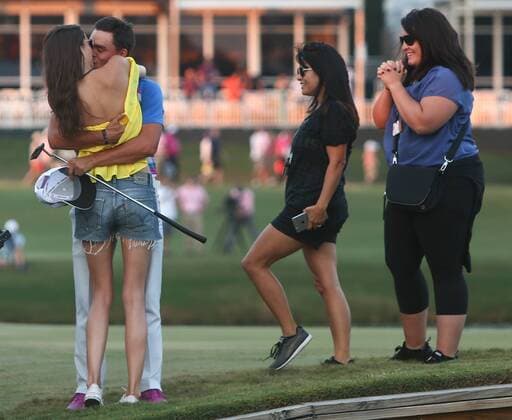May 10, 2015 - Ponte Vedra Beach, Florida, United States - Rickie Fowler kisses his girlfriend Alexis Randock as his mother Lynn Fowler (2nd R) and sister Taylor Fowler (R) look on the 17th green after winning the sudden death playoff round of THE PLAYERS Championship. THE PLAYERS Championship - Final Round - ZUMAw109