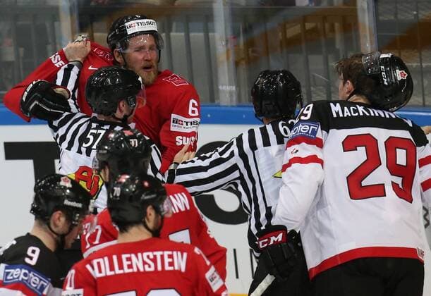 PRAGUE, CZECH REPUBLIC. MAY 10, 2015. Switzerland s Timo Helbling (L background) and Canada s Nathan Mackinnon (R) seen in their 2015 IIHF World Championship WM Weltmeisterschaft Preliminary Round Group A Ice hockey Eishockey match at O2 Arena. The Canadian team won the game 7:2. Yelena Rusko TASS  TS0022DD