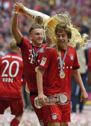 23.05.2015, Fussball 1.Bundesliga 2014 2015, 34.Spieltag, FC Bayern München - 1.FSV Mainz 05, in der Allianz-Arena München, Sänger Andrew Withe (Amerika, USA) singt die Bayern Vereinshymne Stern des Südens. Sinan Kurt (Bayern) überschüttet hier Gianluca Gaudino (Bayern) 