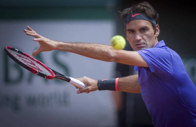 (150524) -- PARIS, May 24, 2015 -- Roger Federer of Switzerland returns a shot during the men s singles first round match against Alejandro Falla of Colombia at Roland Garros, Paris, France on May 24, 2015. Roger Federer won 3-0 and advanced to the second round. ) (SP)FRANCE-PARIS-TENNIS-ROLAND GARROS-FIRST ROUND chenxxiaowei 